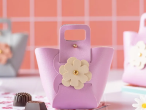 a small pink purse with a flower decoration