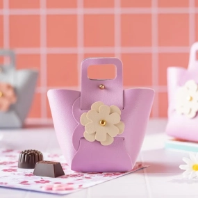a small pink purse with a flower decoration